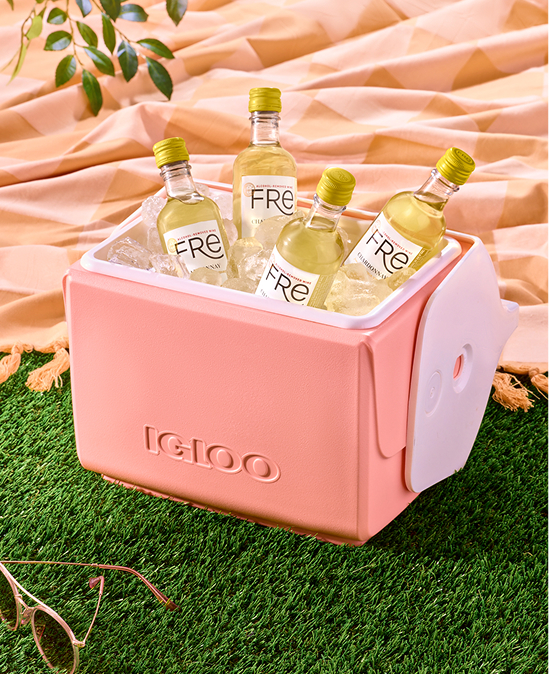 A pink Igloo cooler is filled with ice and mini 187ml bottles of Fre Alcohol-Removed Chardonnay white wine